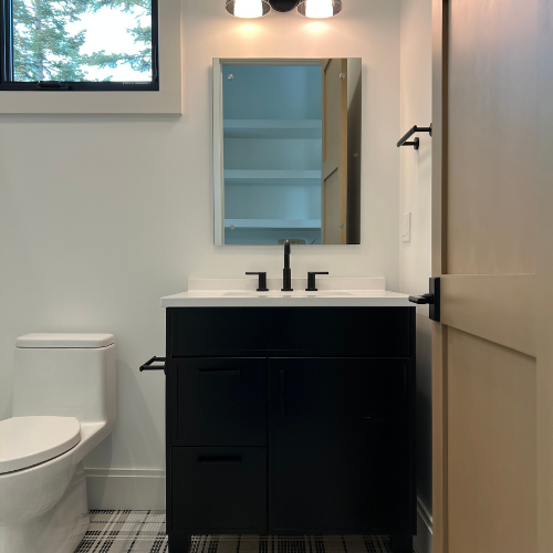 showroom bathroom, black cabinet, mirror